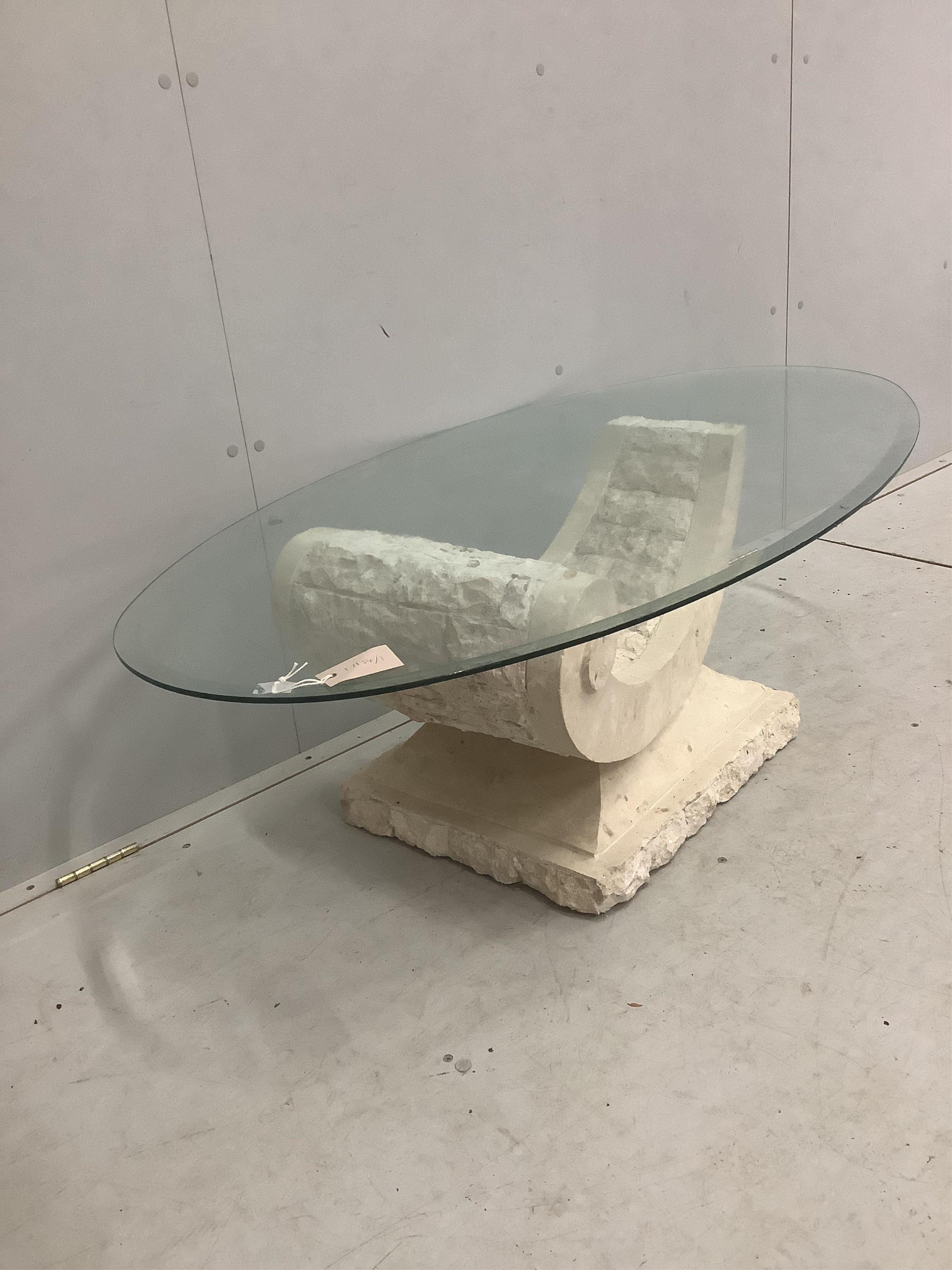 A Contemporary Italian design oval glass coffee table on composite 'C' scroll base, width 130cm, depth 70cm, height 41cm. Condition - good